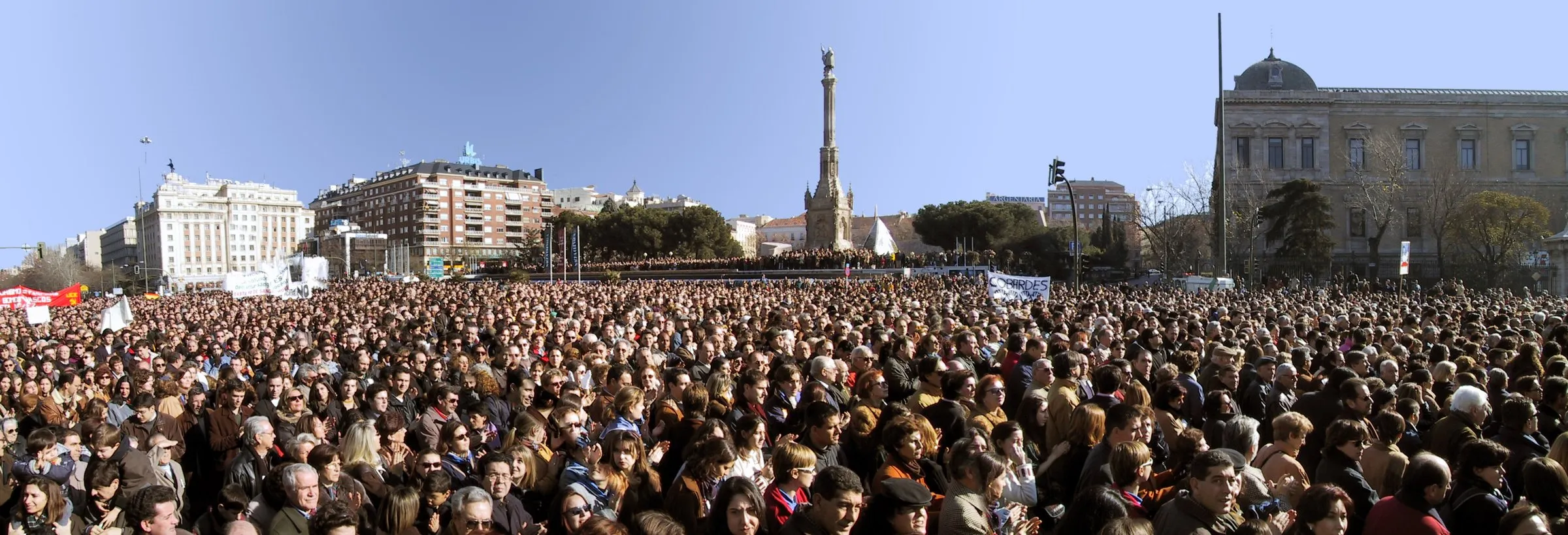 A crowd fills Madrid's Plaza de Colón during a demonstration against ETA, with the Columbus column in the background