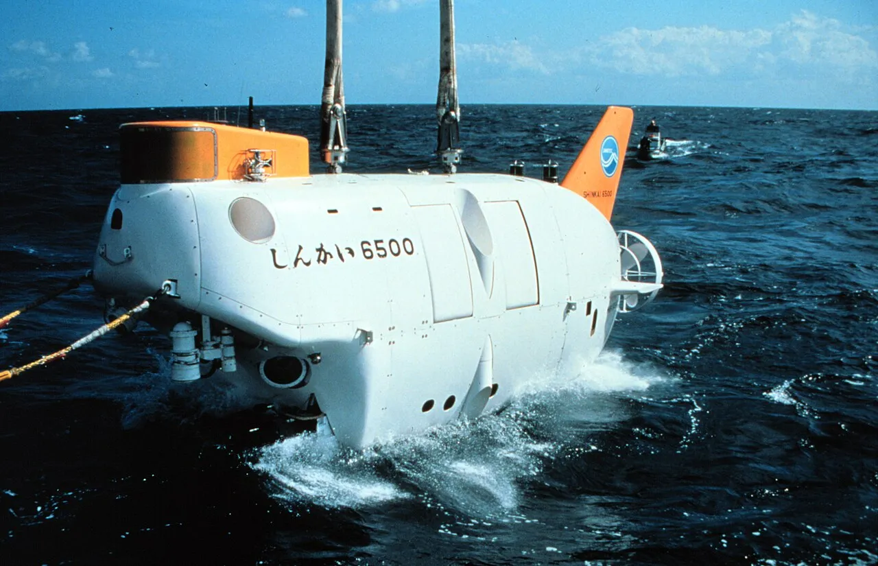 The white and orange Japanese submersible Shinkai 6500 at the sea surface