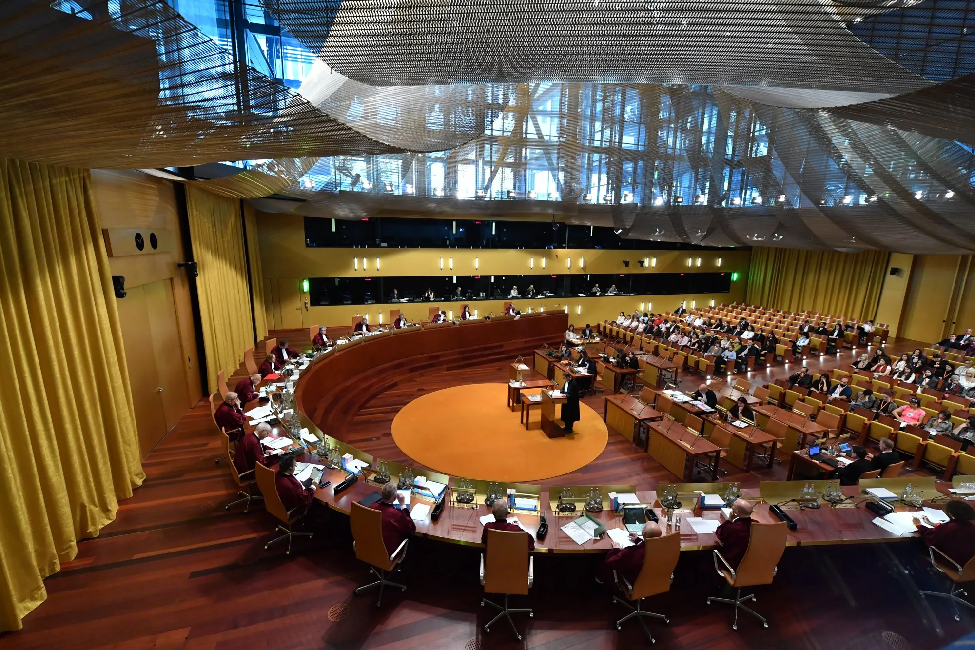 A Grand Chamber hearing at the Court of Justice of the European Union, with judges in red robes seated in a semicircle